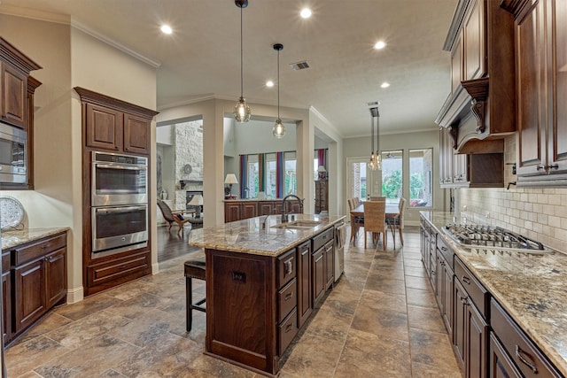 21610 Harbor Water Dr, Cypress, TX 77433 - kitchen featuring stainless steel appliances, a sink, decorative backsplash, light stone counters, and recessed lighting