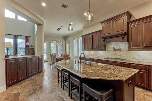 21610 Harbor Water Dr, Cypress, TX 77433 - kitchen with a sink, tasteful backsplash, ornamental molding, light stone countertops, and a breakfast bar