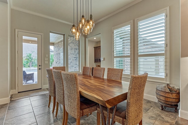 21610 Harbor Water Dr, Cypress, TX 77433 - dining space featuring ornamental molding, healthy amount of natural light, stone tile flooring, a chandelier, and baseboards