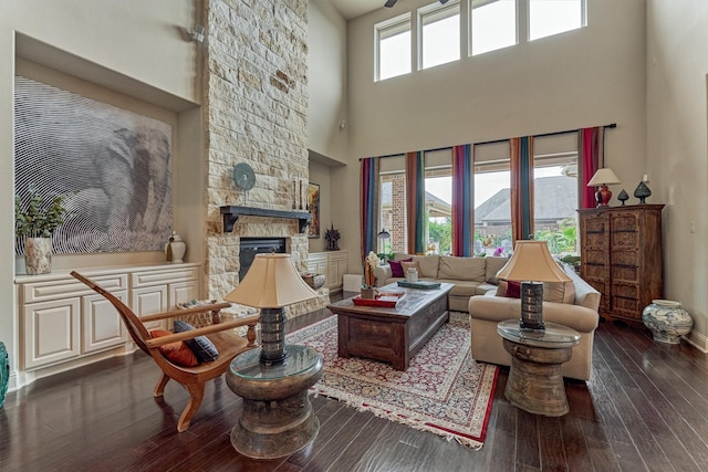 21610 Harbor Water Dr, Cypress, TX 77433 - living room with a high ceiling, wood-type flooring, a fireplace, and baseboards