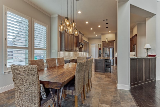 21610 Harbor Water Dr, Cypress, TX 77433 - dining space with crown molding, baseboards, dark stone finish floors, and recessed lighting
