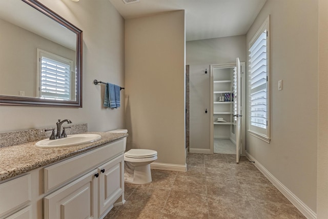 21610 Harbor Water Dr, Cypress, TX 77433 - full bath featuring vanity, toilet, a walk in closet, and baseboards