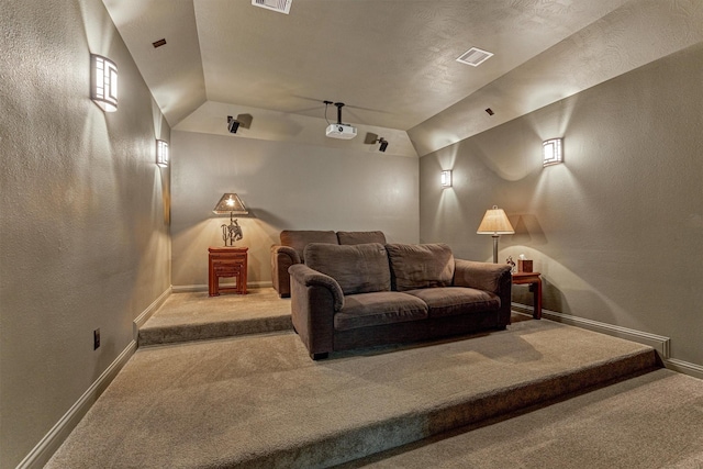 21610 Harbor Water Dr, Cypress, TX 77433 - carpeted home theater featuring vaulted ceiling, a textured wall, and baseboards
