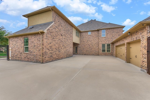 21610 Harbor Water Dr, Cypress, TX 77433 - view of side of home featuring concrete driveway, brick siding, a garage, and a patio area