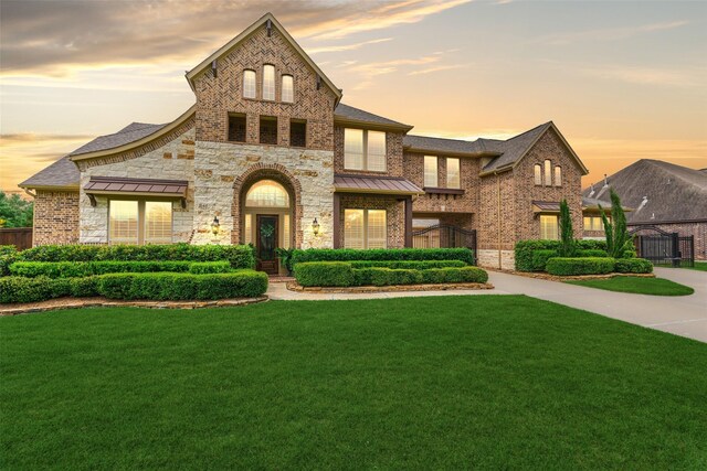 21610 Harbor Water Dr, Cypress, TX 77433 - french country inspired facade with a standing seam roof, brick siding, and stone siding