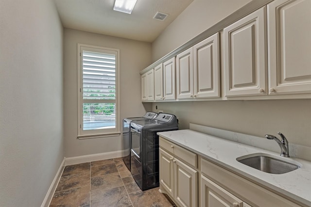 21610 Harbor Water Dr, Cypress, TX 77433 - laundry area with cabinet space, washing machine and dryer, and dark stone finish flooring