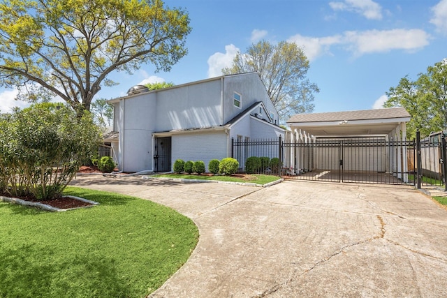 view of side of home featuring a yard, a gate, driveway, and fence