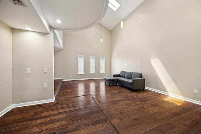 unfurnished room with dark wood-style floors, visible vents, and baseboards