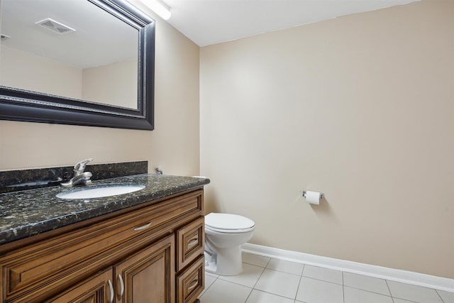 bathroom featuring visible vents, baseboards, toilet, tile patterned floors, and vanity