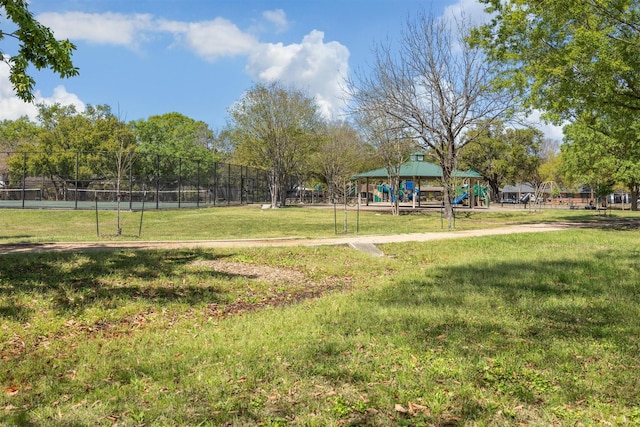 view of yard featuring playground community and fence
