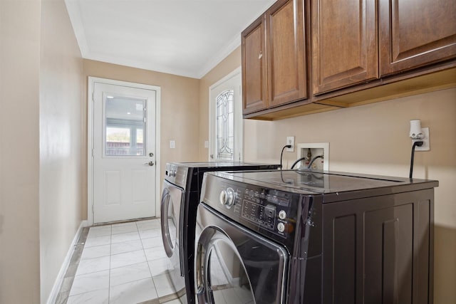 washroom with ornamental molding, washing machine and clothes dryer, cabinet space, and baseboards