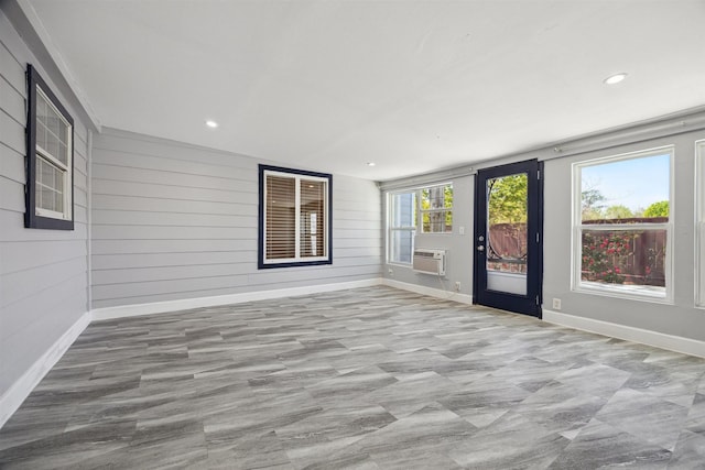 interior space featuring baseboards, wooden walls, and recessed lighting