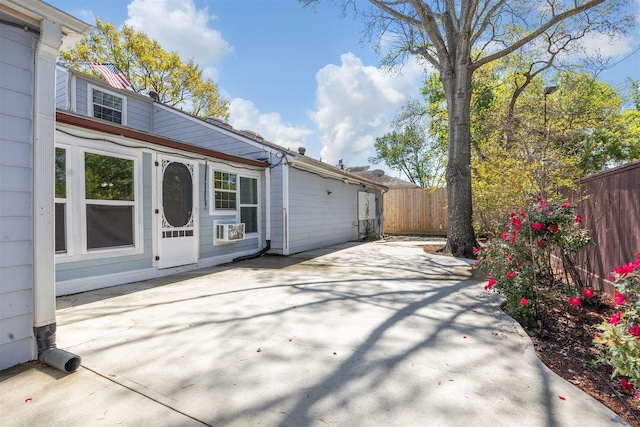 exterior space featuring a patio area, cooling unit, and fence