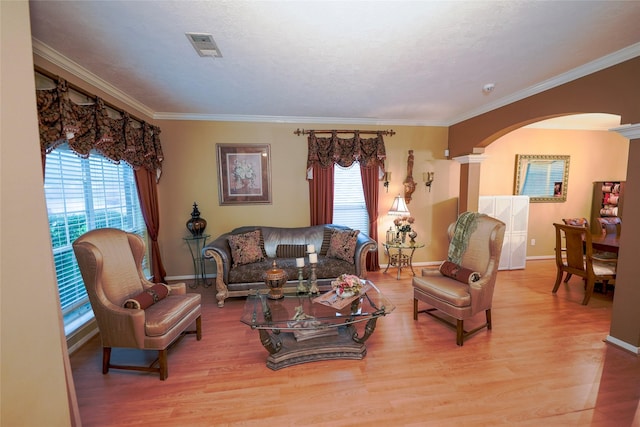 6019 Spanish Oak Dr, Pasadena, TX 77505 - living area with arched walkways, plenty of natural light, crown molding, and baseboards