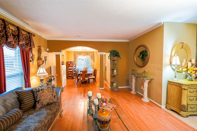 6019 Spanish Oak Dr, Pasadena, TX 77505 - living area with crown molding, light wood-type flooring, arched walkways, an inviting chandelier, and ornate columns