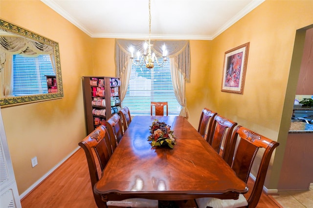 6019 Spanish Oak Dr, Pasadena, TX 77505 - dining space featuring light wood-style flooring, baseboards, a notable chandelier, and crown molding