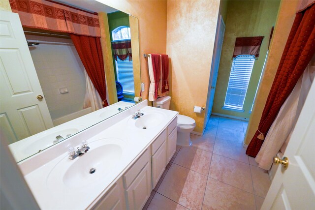 6019 Spanish Oak Dr, Pasadena, TX 77505 - bathroom with double vanity, tile patterned floors, toilet, and a sink
