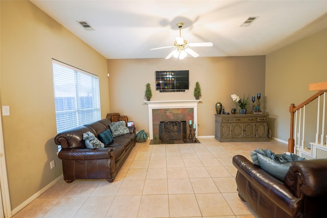 6019 Spanish Oak Dr, Pasadena, TX 77505 - living area with a tile fireplace, visible vents, light tile patterned floors, stairs, and ceiling fan