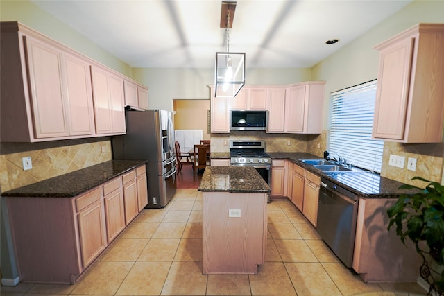 6019 Spanish Oak Dr, Pasadena, TX 77505 - kitchen featuring dark stone counters, a center island, tasteful backsplash, a sink, and appliances with stainless steel finishes