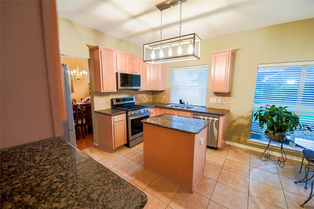 6019 Spanish Oak Dr, Pasadena, TX 77505 - kitchen featuring a center island, decorative backsplash, light brown cabinetry, a chandelier, and appliances with stainless steel finishes