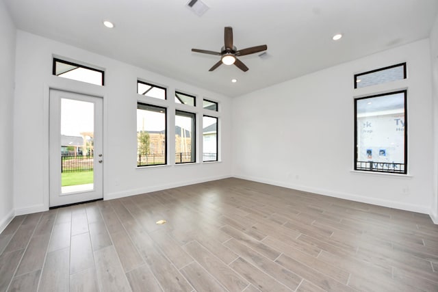 14647 Cedar Elm Ct, Willis, TX 77318 - empty room with wood finished floors, ceiling fan, and recessed lighting