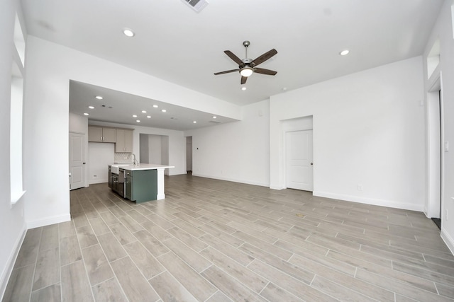 14647 Cedar Elm Ct, Willis, TX 77318 - unfurnished living room featuring a ceiling fan, light wood-style flooring, and recessed lighting