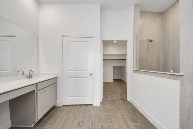 14647 Cedar Elm Ct, Willis, TX 77318 - full bathroom featuring a walk in shower, vanity, wood tiled floors, and a walk in closet