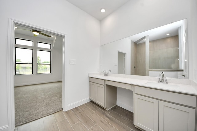 14647 Cedar Elm Ct, Willis, TX 77318 - bathroom featuring double vanity, a ceiling fan, a tile shower, recessed lighting, and wood finish floors