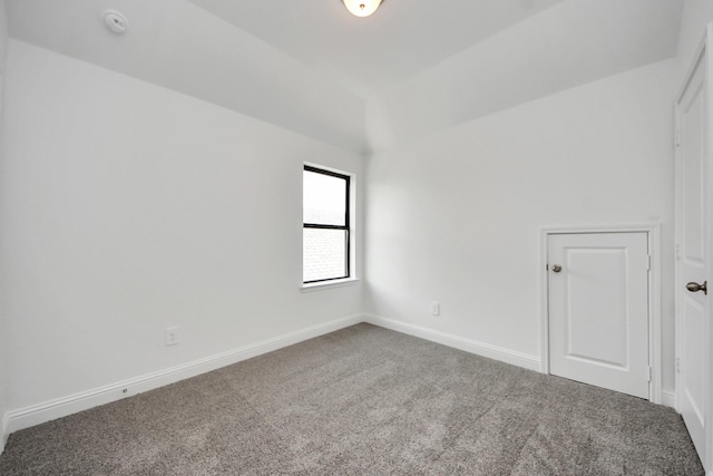 14647 Cedar Elm Ct, Willis, TX 77318 - carpeted spare room featuring baseboards and vaulted ceiling