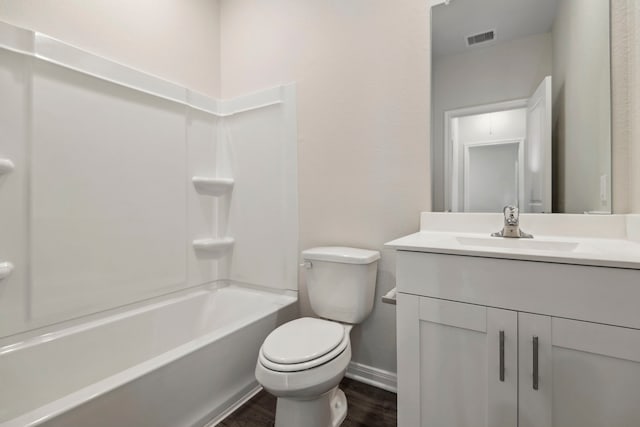 bathroom with vanity, toilet, baseboards, wood finished floors, and visible vents
