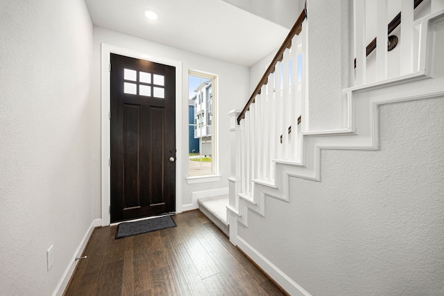 entrance foyer with recessed lighting, dark wood-style floors, stairway, and baseboards