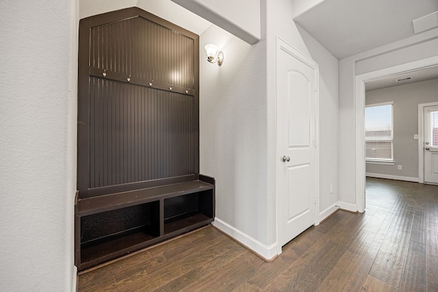 mudroom with baseboards, visible vents, and dark wood-style flooring