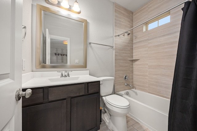 full bathroom featuring vanity, toilet, a textured wall, shower / tub combination, and wood finished floors