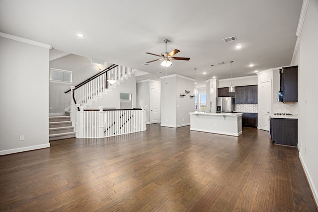 unfurnished living room with crown molding, dark wood-type flooring, and a ceiling fan