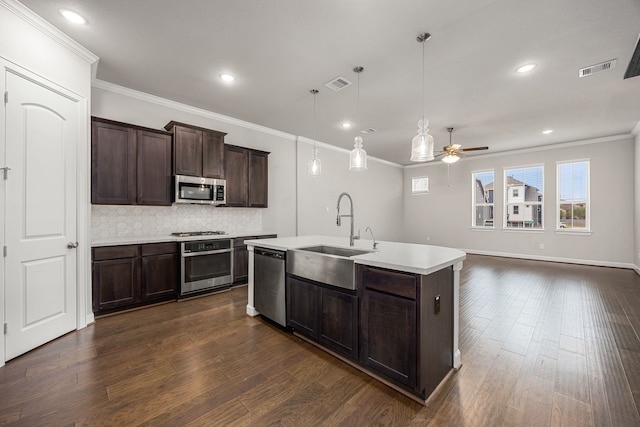 kitchen with dark wood-style flooring, ceiling fan, light countertops, and appliances with stainless steel finishes