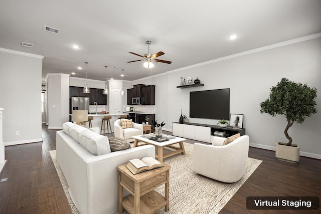 living area with dark wood-type flooring, crown molding, ceiling fan, and visible vents