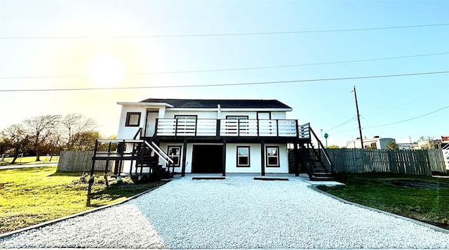 4406 Helen St, Hitchcock, TX 77563 - view of front facade featuring a front yard, fence, stairs, and a wooden deck