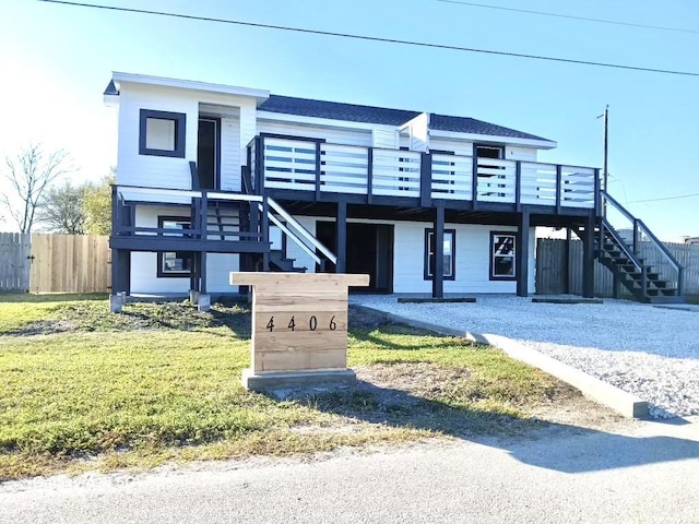 4406 Helen St, Hitchcock, TX 77563 - view of front of home featuring a wooden deck, fence, stairs, and a front lawn