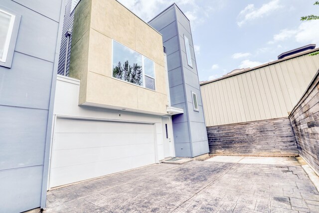 view of front of home with driveway, a garage, and stucco siding