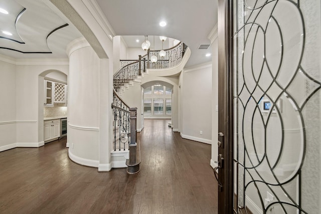 5730 Balcones Ridge Ln, Houston, TX 77059 - foyer with visible vents, stairs, dark wood finished floors, arched walkways, and beverage cooler