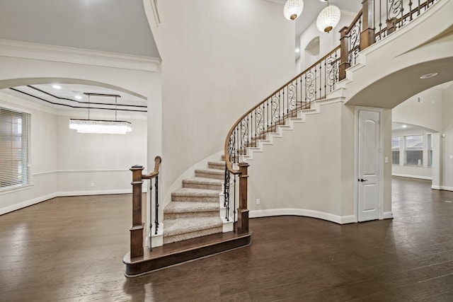 5730 Balcones Ridge Ln, Houston, TX 77059 - stairway with baseboards, arched walkways, wood finished floors, and ornamental molding