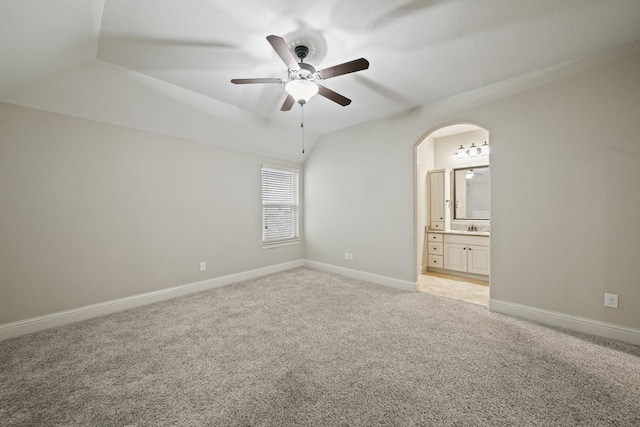 5730 Balcones Ridge Ln, Houston, TX 77059 - unfurnished bedroom with lofted ceiling, light colored carpet, baseboards, arched walkways, and connected bathroom