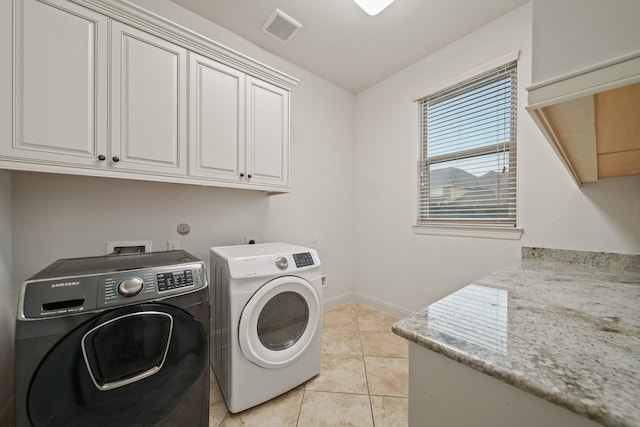 5730 Balcones Ridge Ln, Houston, TX 77059 - laundry area with light tile patterned flooring, baseboards, visible vents, washer and dryer, and cabinet space