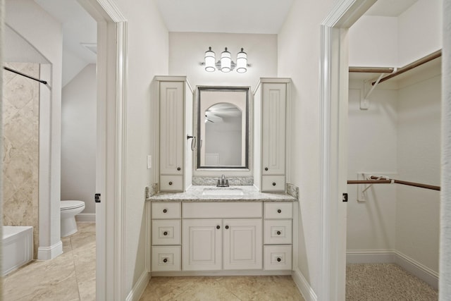 5730 Balcones Ridge Ln, Houston, TX 77059 - full bath with toilet, vanity, a walk in closet, and baseboards