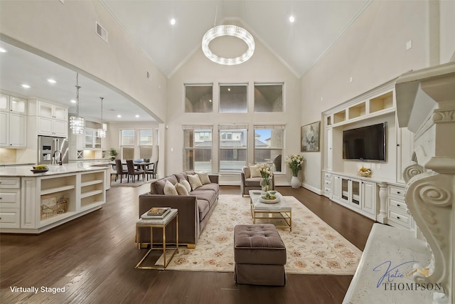 5730 Balcones Ridge Ln, Houston, TX 77059 - living area featuring crown molding, high vaulted ceiling, dark wood-type flooring, arched walkways, and visible vents