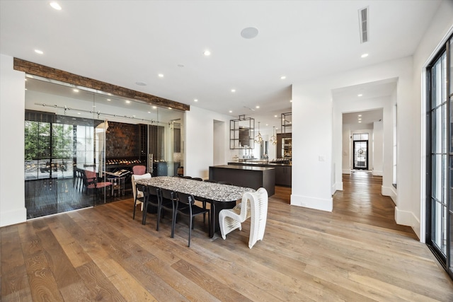3835 Olympia Dr, Houston, TX 77019 - dining area with light wood-style floors, recessed lighting, and baseboards