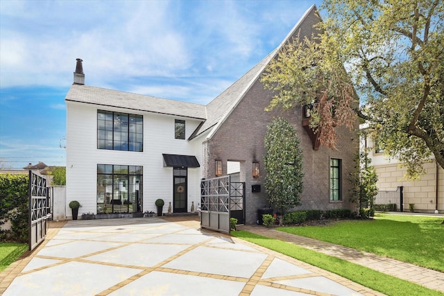 3835 Olympia Dr, Houston, TX 77019 - view of front of property with a patio area and a chimney