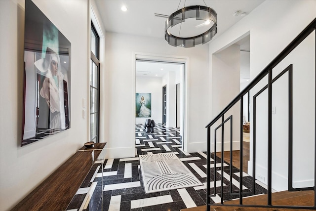 3835 Olympia Dr, Houston, TX 77019 - hall featuring stairs, recessed lighting, inlaid floor details, and baseboards