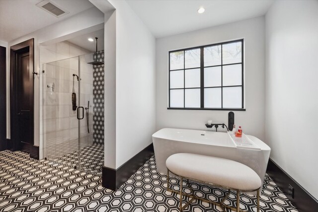 3835 Olympia Dr, Houston, TX 77019 - bathroom with a soaking tub, a stall shower, recessed lighting, and baseboards