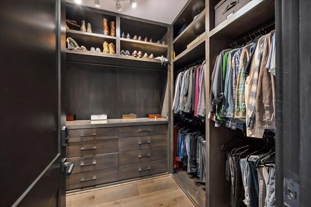 3835 Olympia Dr, Houston, TX 77019 - walk in closet with wood finished floors